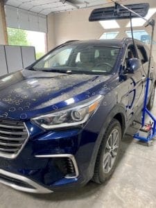 Car in shop marked for Paintless Dent repair