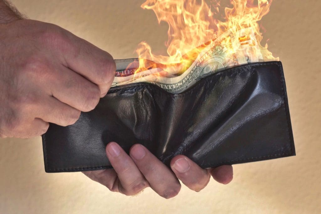 money on fire in a wallet